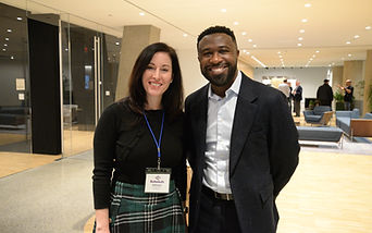 Two attendees posing together with name badges